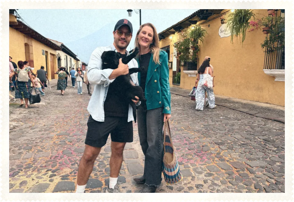 Katie and Carlos on a cobbled street with their puppy